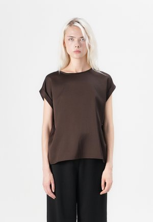 Brown short-sleeve top with a loose fit and rounded neckline, made from smooth fabric. Features rolled sleeves and subtle side seam details.