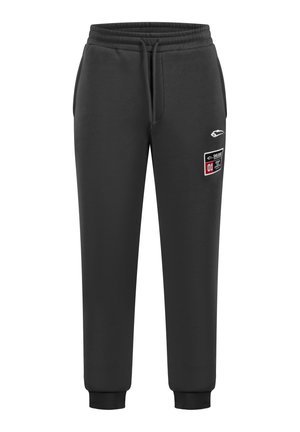 Pantaloni sportivi neri con elastico in vita, cordoncino e polsini a costine. Presenta un logo e una patta rettangolare con dettagli testuali.