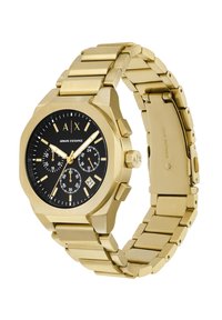 Kuldne roostevabast terasest kell musta dial'iga, kuhu on paigutatud kuus kronograafi aladialki, kuupäevakannet, julgeid tunni markereid ja kett käevõru.