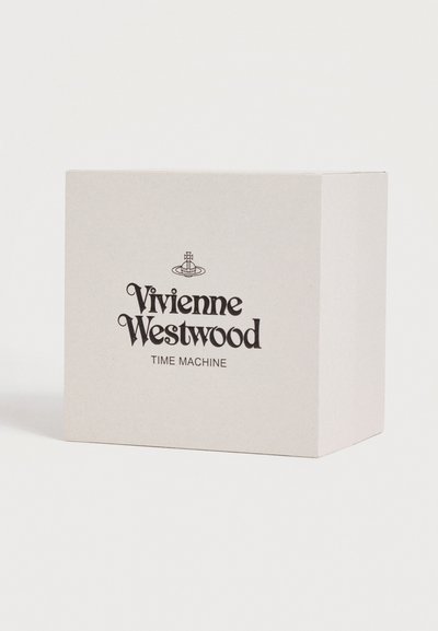 Άσπλη συσκευασία κουτιού με το λογότυπο Vivienne Westwood και το κείμενο "TIME MACHINE" στο κέντρο μπροστά σε απλό λευκό φόντο.
