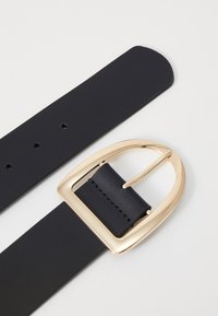 Black leather belt with a gold metal buckle, featuring a rectangular shape and smooth texture, with multiple holes for sizing adjustments.