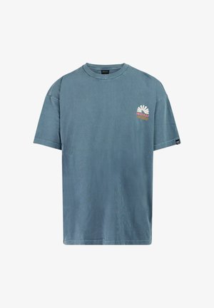 Blue short-sleeve crew neck T-shirt with small white and orange flower logo and "PROTEST" text on the left chest.