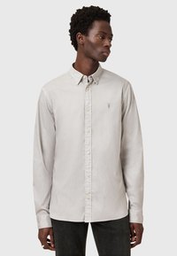 Lichtgrijze button-up shirt van katoen. Voorzien van een klassieke kraag, lange mouwen en een klein geborduurd logo op de borst.