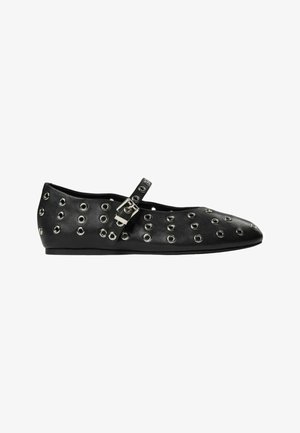 Black leather flats with silver eyelet detailing, a strap with a buckle, pointed toe design, and a flat sole. Smooth texture.