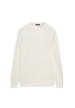 Chemise à manches longues et col rond de couleur blanc cassé, confectionnée dans un tissu doux à la texture lisse, présentant un design simple et épuré.