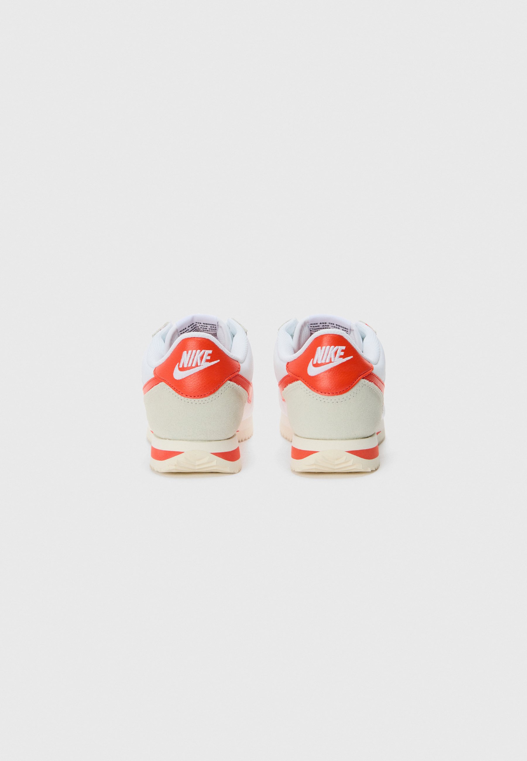 white nike shoes with orange stripe