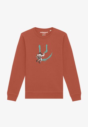 Sweat-shirt couleur rouille avec un graphique d'astronaute et des éclaboussures de peinture turquoise. Manches longues, col ras du cou et texture de tissu douce.