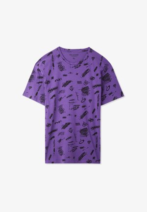 T-shirt viola a maniche corte, vestibilità rilassata, con motivi e schizzi astratti neri su tutto il tessuto. Realizzata in morbido cotone.
