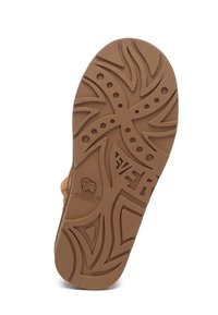 Tan rubber shoe sole featuring an intricate pattern with curved lines and dots, embossed logo reading "EVERAU." Durable texture and design.