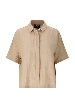 Chemise beige à manches courtes avec une finition texturée, boutonnée sur le devant, et col. Design décontracté, large avec une coupe légèrement oversize.