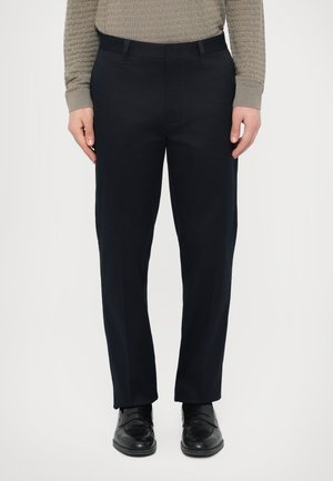 - Spodnie materiałowe