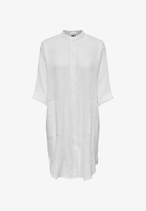 Valkoinen pitkä paitamekko, jossa mandariinikaulus, edessä napit, kolmen neljänneksen pituiset kääritty hihat ja kaksi etutaskua.