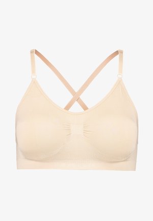 Beež wireless rinnahoidja sujuva tekstuuriga, V-kaeluse disainiga ja ristuvad rihmad. Keskpaneelis on kogutud detailid.