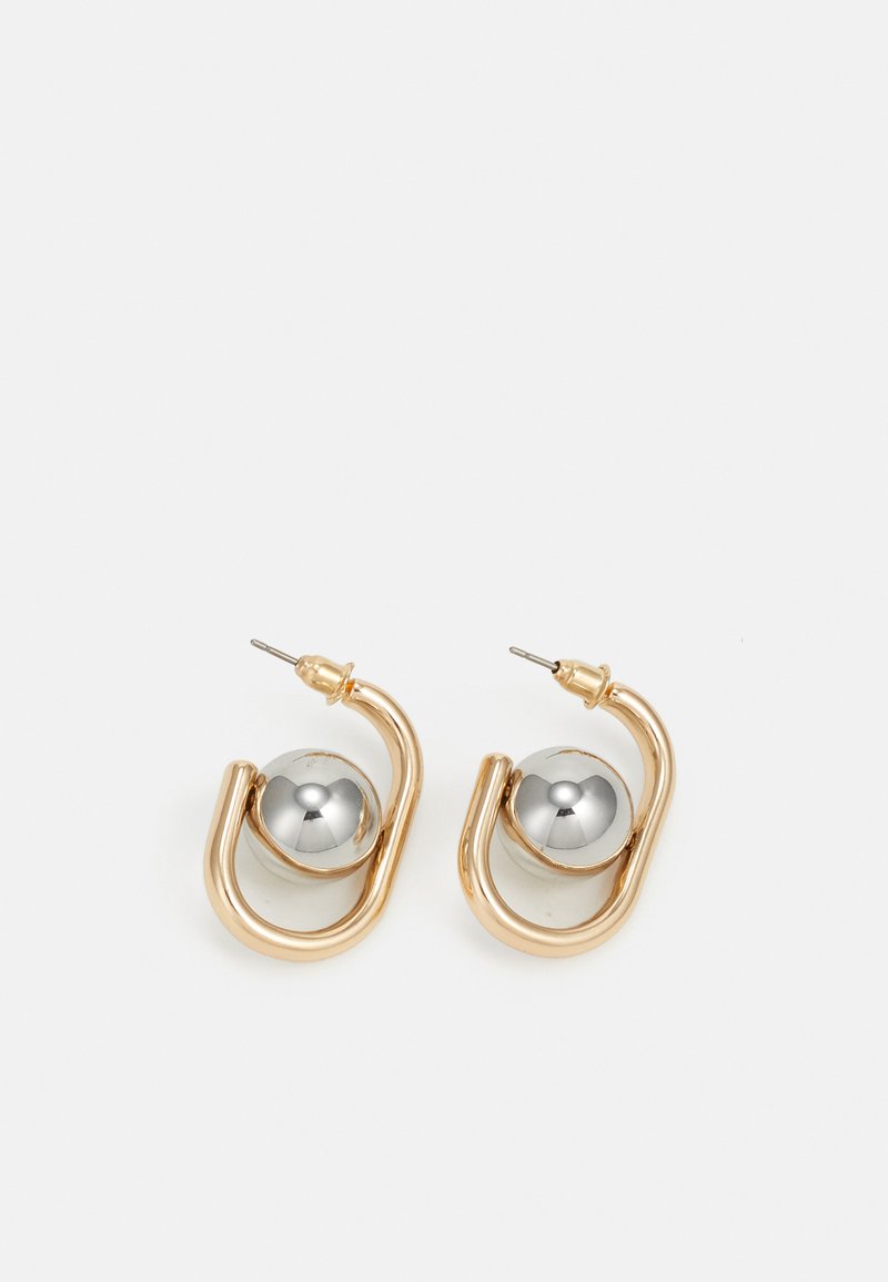 Gold-tone earrings with a curved, hoop-like design featuring a prominent silver spherical accent. Polished metal finish, post-back closure.