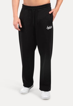 Pantalones deportivos - schwarz