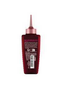 Bouteille en plastique rouge avec un capuchon à buse étroite. L'étiquette arrière présente un texte blanc et un code-barres, détaillant l'utilisation du produit et les ingrédients. Taille de 102 ml.