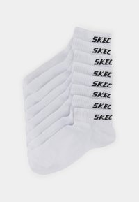 White crew socks with ribbed cuffs, featuring black "SKECHERS" logo. Twelve pairs neatly arranged, made from a soft, breathable fabric.