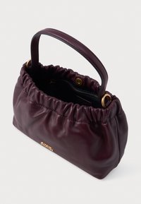 Burgundi odinė rankinė su surinkta viršūne, auksiniais aksesuarais ir lygiu paviršiumi. Yra viršutinė rankena nešimui.