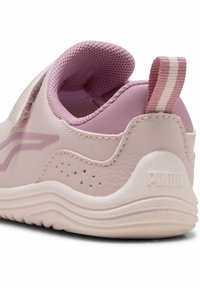 Light pink sneaker with smooth leather upper, textured mesh collar, and rubber sole. Features a small logo and striped pull tab.