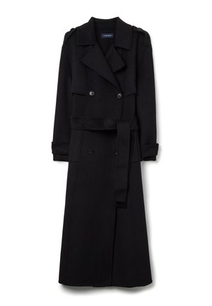 Manteau long en laine noire avec des boutons doublés, col cranté, taille ceinturée et épaulettes, présentant une silhouette épurée et bien ajustée.