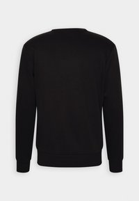 Sweat-shirt noir uni à manches longues avec poignets et ourlet côtelés, vu de dos sur un fond clair neutre.