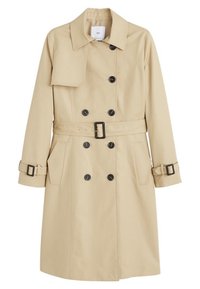 Trench-coat beige croisé avec des boutons noirs, ceinture assortie avec boucle, bracelets aux poignets et poches latérales, présenté sur un fond blanc.