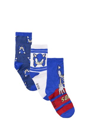 Trois paires de chaussettes présentant des tons de bleu. Une paire affiche le visage de Sonic, une autre a un fond blanc avec des rayures bleues, et la dernière est rouge avec un graphisme et des rayures.