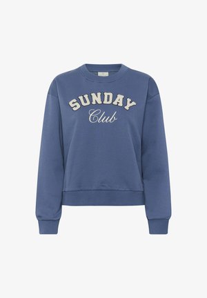 Modra pulover s krožnim izrezom in napisom "SUNDAY Club" natisnjenim spredaj v belih teksturiranih črkah ter dolgimi rebrastimi manšetami.