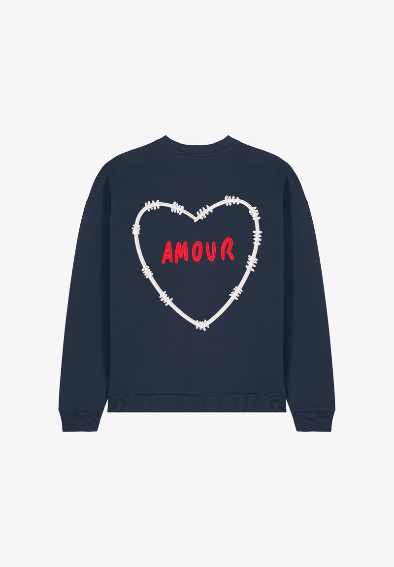 Donkerblauwe sweatshirt met een wit barbed wire hartontwerp. Het woord "AMOUR" is in het rood geborduurd binnen het hart. Ronde hals, geribbelde manchetten.