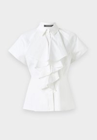 White blouse featuring a collared neckline and short sleeves. Ruffled detailing runs down the center, made from smooth cotton fabric.