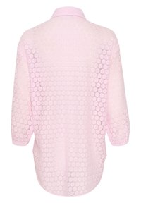Light pink blouse with a sheer, textured lace pattern featuring circular motifs and a collared neckline. Three-quarter sleeves, relaxed fit.