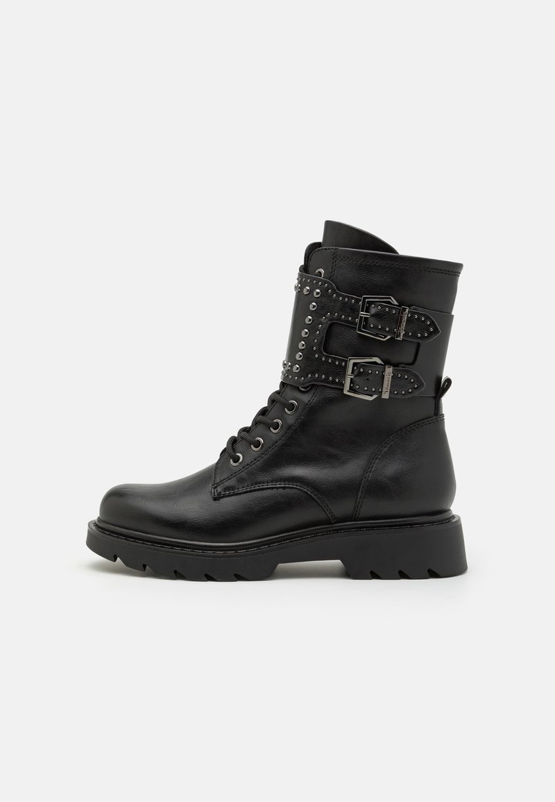 Black leather ankle boot with a rounded toe, lace-up front, two buckles, and metallic studs on a textured panel. Chunky sole design.