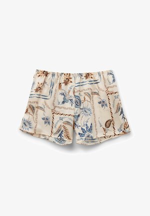 Floral print shorts in cream with blue and brown designs. Elastic waistband with ruffled edges, lightweight fabric, and a relaxed fit.