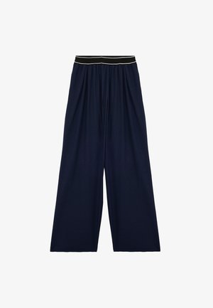 Pantalones de pierna ancha de color marino, confeccionados en un tejido suave, con una cinturilla elástica que presenta una franja blanca en contraste y un diseño suelto y fluido.