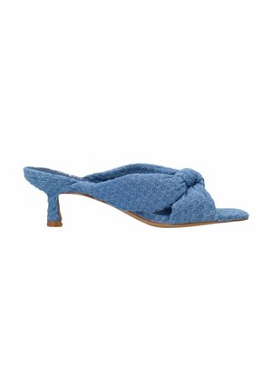 Blue textile mules with a knotted design at the front, pointed toe, and a 2-inch kitten heel. Textured surface with woven pattern.