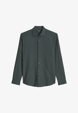 Donkergroen shirt met lange mouwen, een gestructureerde stof, een puntige kraag en een knoopsluiting aan de voorkant. Zes bijpassende knopen langs de knoopsluiting.