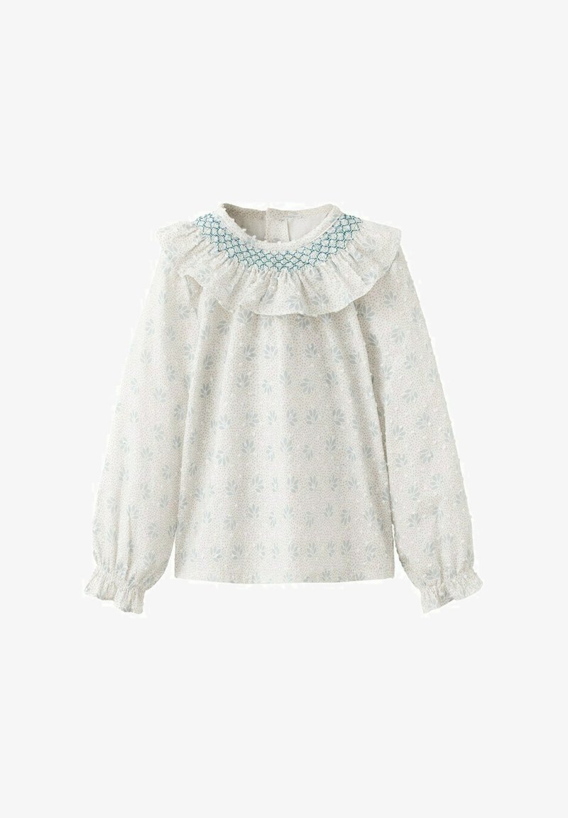 Blouse blanche à manches longues avec un petit motif floral, col à volants avec smocks bleu sarcelle, et poignets élastiques à volants.