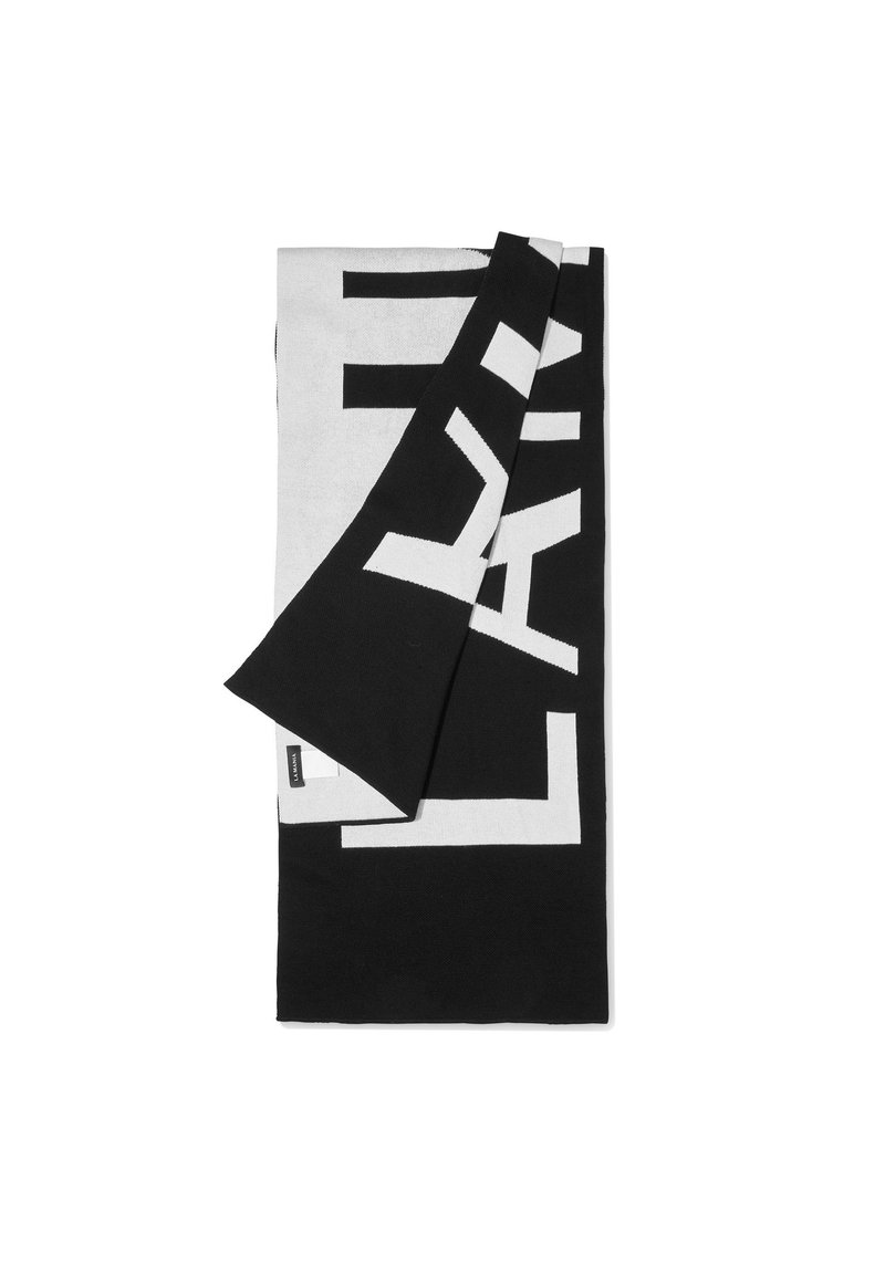 Prosop alb și negru cu un design de text îndrăzneț. Material moale cu un model geometric contrastant și o etichetă de marcă pe margine.