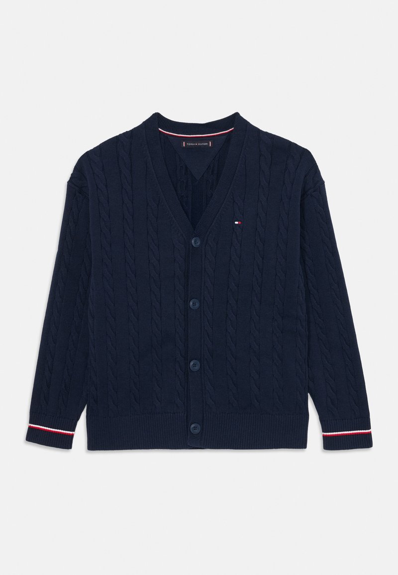 Cardigan azul-marinho com padrão de ponto de cabo, decote em V, seis botões, punhos e parte inferior canelados, apresentando um pequeno detalhe de logotipo em vermelho, branco e azul.