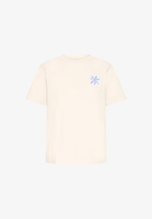 Bombažna majica krem barve s kratkimi rokavi, z modrim cvetličnim motivom z rdečim središčem na levi strani prsnega koša.