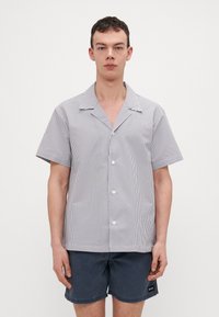 Srajca s kratkimi rokavi in gumbi z bleščečim modro-belih črtah, z širokim ovratnikom in gladkim bombažnim materialom.