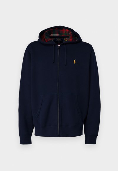 Hoodie zippé marine en mélange de coton. Présente une doublure à carreaux, des poches avant et un logo brodé en or sur la poitrine.