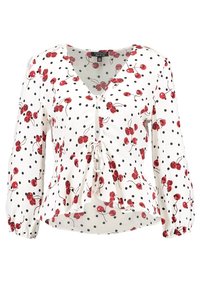 Blouse blanche avec imprimé de cerises rouges et pois noirs. Caractérisée par un col en V, des manches longues, et un lien à la taille. Tissu doux.