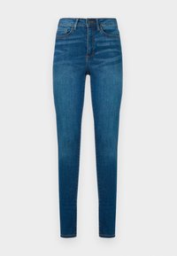 Blå denim skinny jeans med hög midja, med fem fickor, subtil blekning och orange sömnadsdetaljer längs sömmarna.
