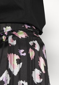 Zwarte geplooide rok met een kleurrijk abstracte print in roze, groen en wit. Inclusief textiel met structuur en een tailleband met een label.