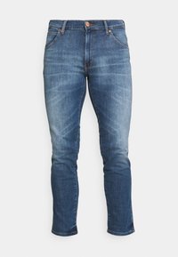 Dark wash denim jeans with a fitted silhouette, straight leg, five pockets, and copper-tone rivets. Features subtle whiskering on the thighs.
