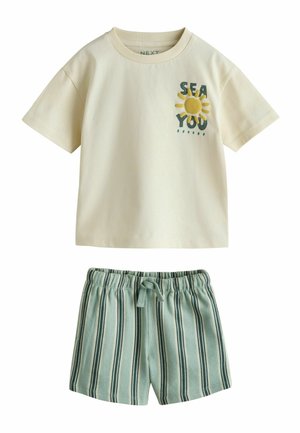 Cream short-sleeve t-shirt with "SEA YOU" and sun graphic paired with light green striped elastic waist shorts with drawstring.
