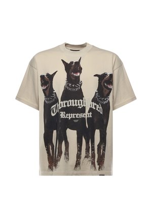 Beige T-shirt met drie zwarte Dobermans met gespikkelde halsbanden en gothic-stijl tekst met de woorden "Thornyghtred Represent."