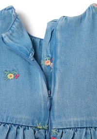 Light blue denim dress with a back zip closure, featuring embroidered floral patterns in pink, yellow, and green near the neckline. Ruffled hem.