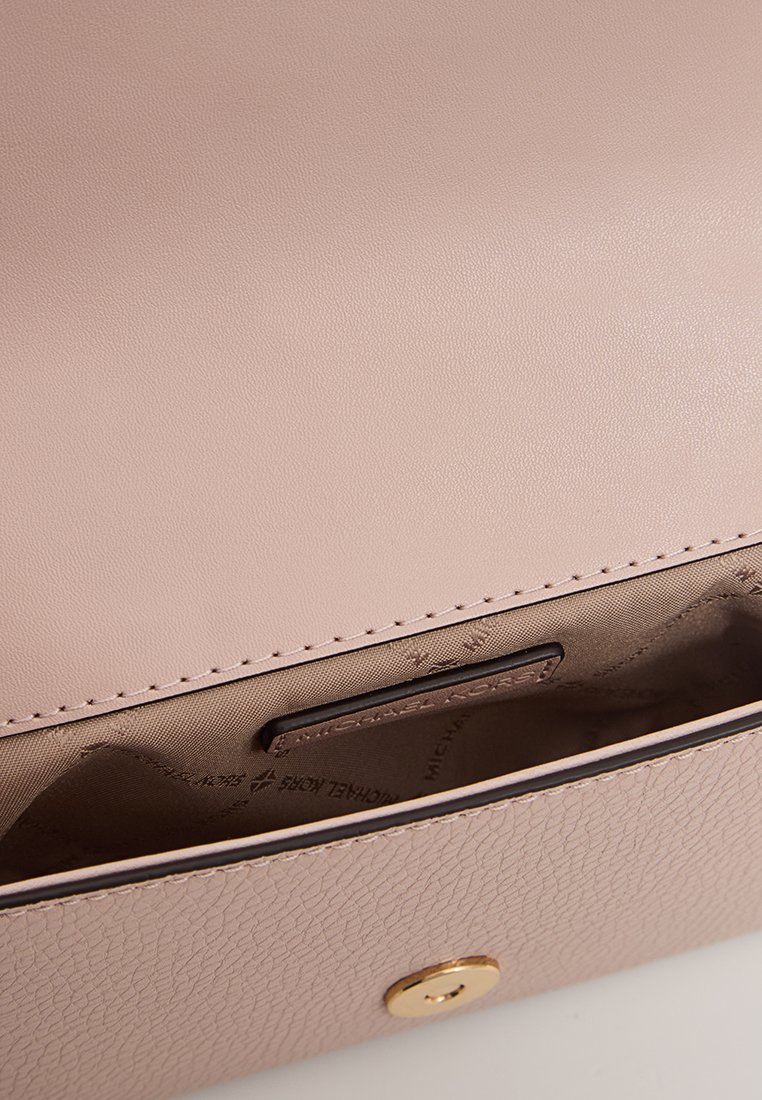 Sac à main en cuir structuré rose clair avec une texture lisse, quincaillerie dorée et un intérieur compartimenté avec un revêtement imprimé du logo.